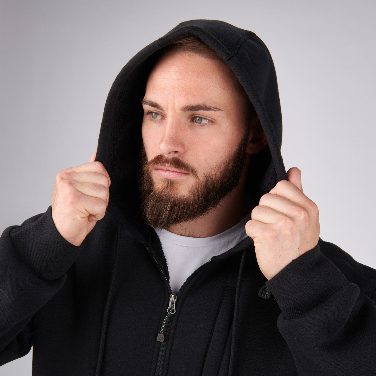 Close up of man wearing Sierra Designs Men's Angora Hoodie, adjusting hood