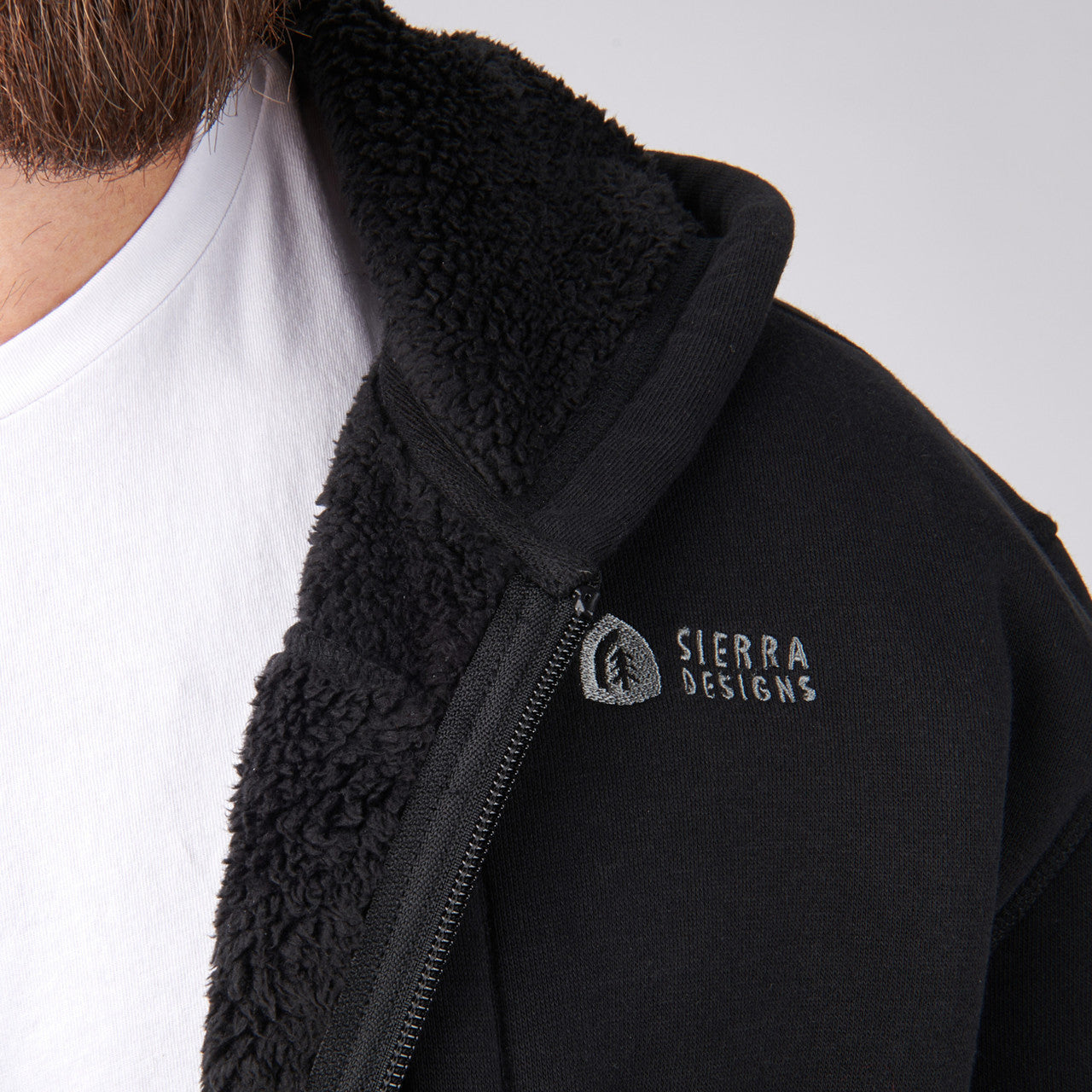 Close up of man wearing Sierra Designs Men's Angora Hoodie, showing Sierra Designs logo