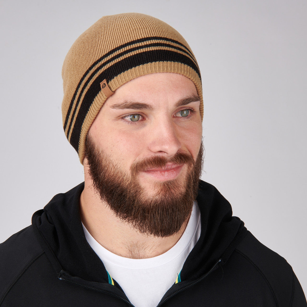 Man wearing Sierra Designs Cleo Reversible Beanie, Cornstalk / Black