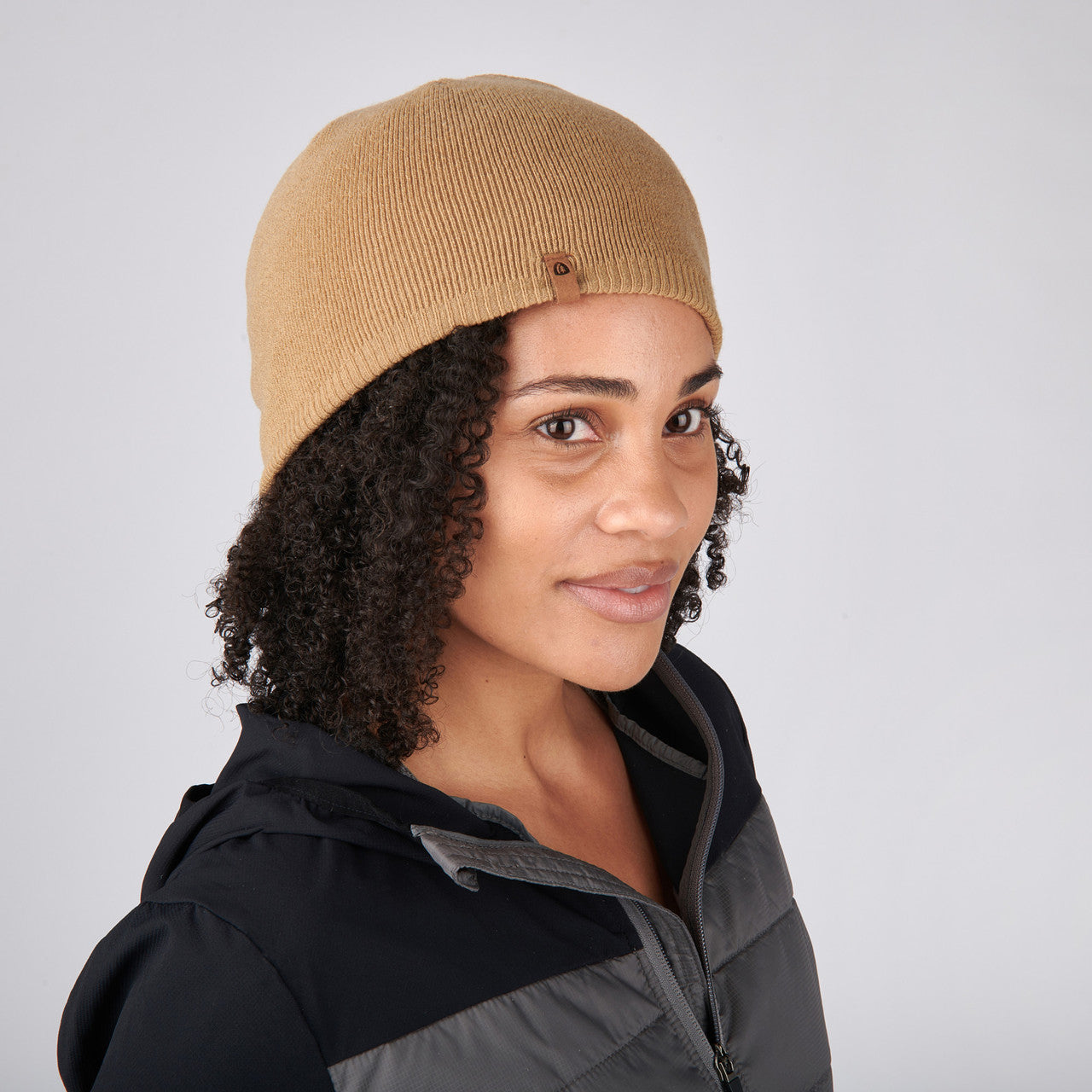 Woman wearing Sierra Designs Cleo Reversible Beanie, Cornstalk / Black