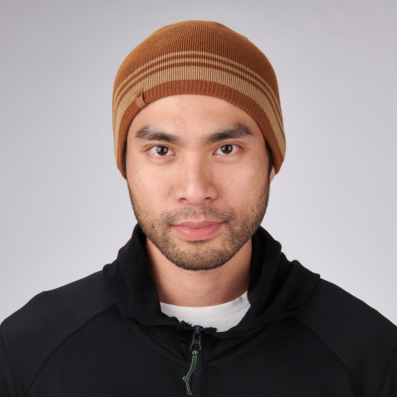 Man wearing Sierra Designs Cleo Reversible Beanie, Dijon / Cornstalk