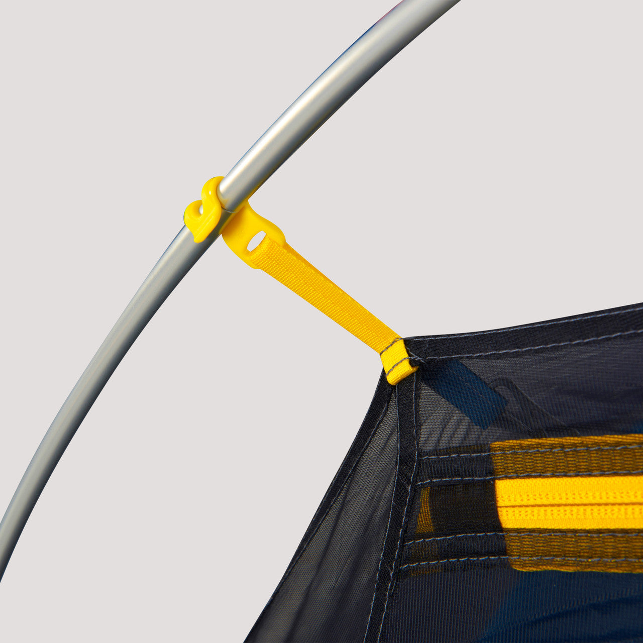 Close up view of a corner of the Sierra Designs Clip Flashlight 2 showing a corner attached to a pole