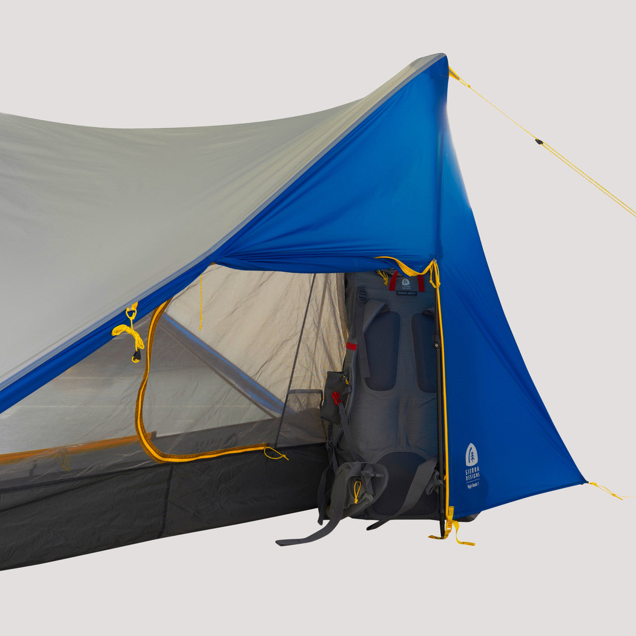 Close up view of the Sierra Designs High Route 1 FL set up with the rain fly completely on and a Sierra Designs backpack in the vestibule area