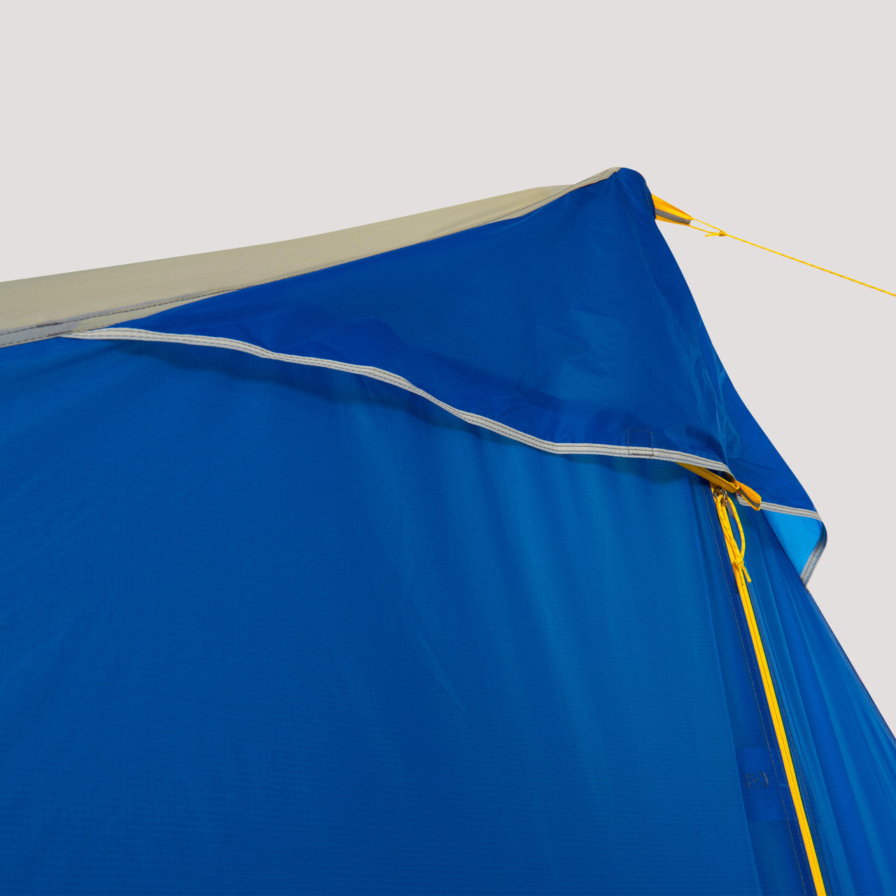 Close up view of the top of the Sierra Designs High Route 1 FL showing the main door zipper, a vent, and a guy line