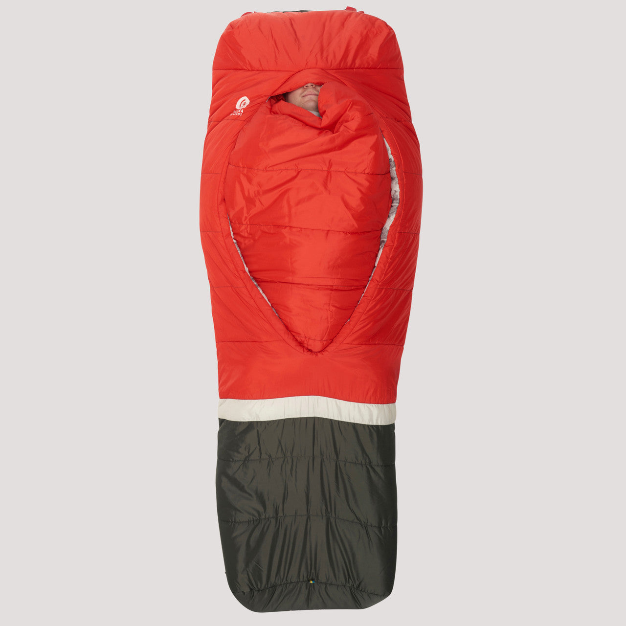 Man sleeping in Sierra Designs Frontcountry Bed 20, with integrated comforter tucked in