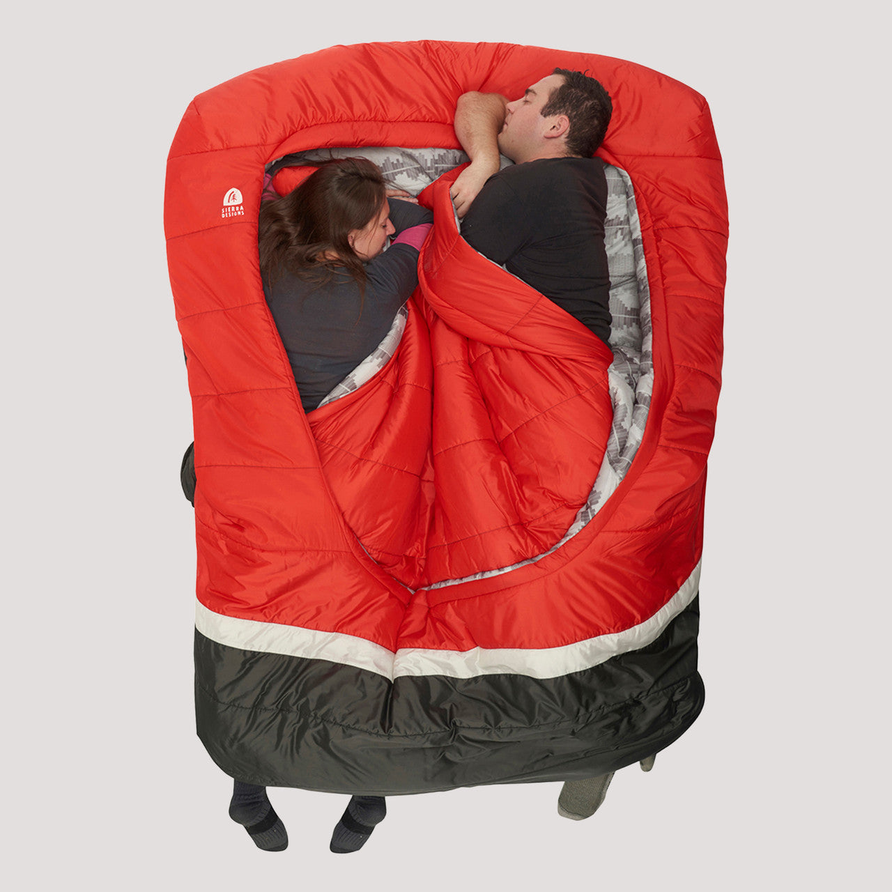 Couple sleeping on their sides in a Sierra Designs Frontcountry Bed 20 Queen
